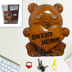 Cute plastic Panda Key Holder with five hooks mounted on a white wall.