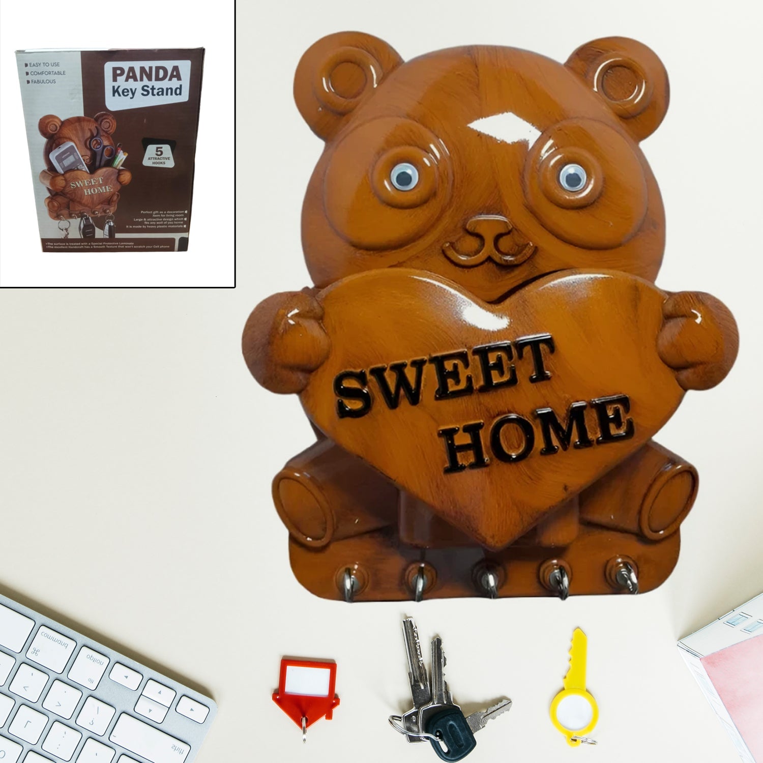 Cute plastic Panda Key Holder with five hooks mounted on a white wall.
