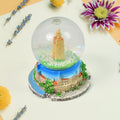 A beautifully crafted decorative snow globe featuring a festive scene, perfect for desk decor.