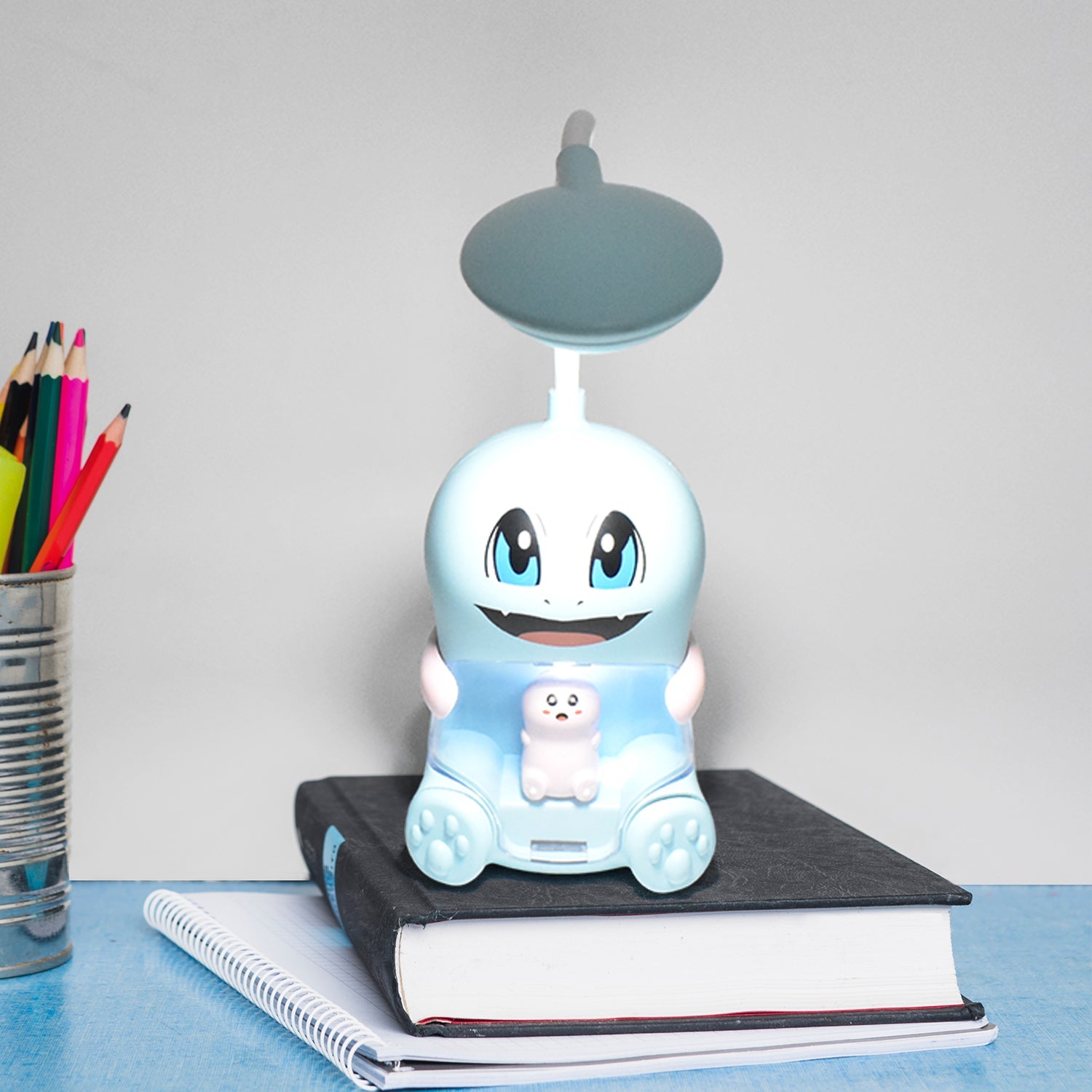 Cartoon LED desk lamp angled to illuminate reading area softly
