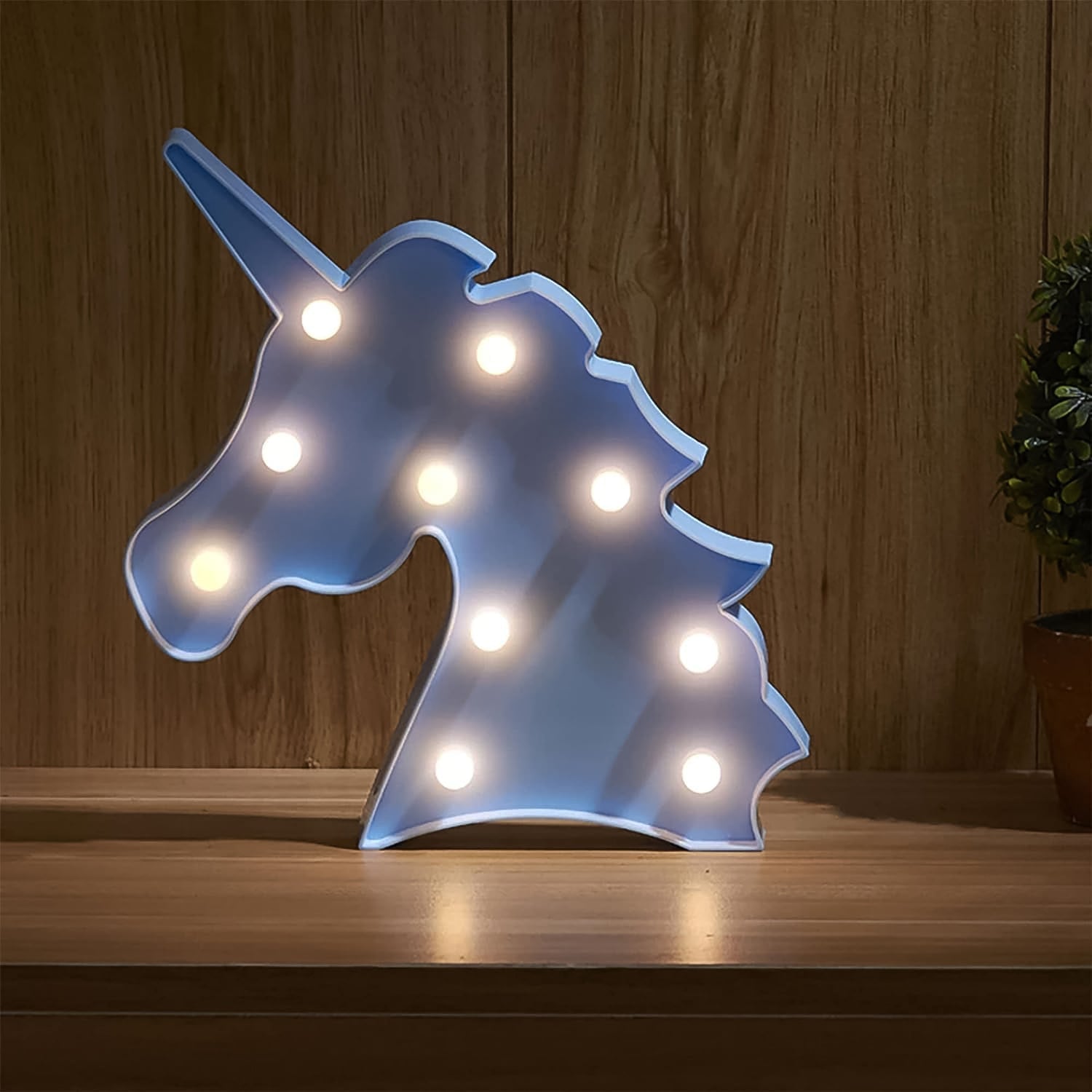 LED table lamp shaped like a unicorn emitting warm light