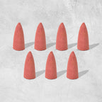 A pack of specialized backflow incense cones, essential for creating the smoke waterfall effect.