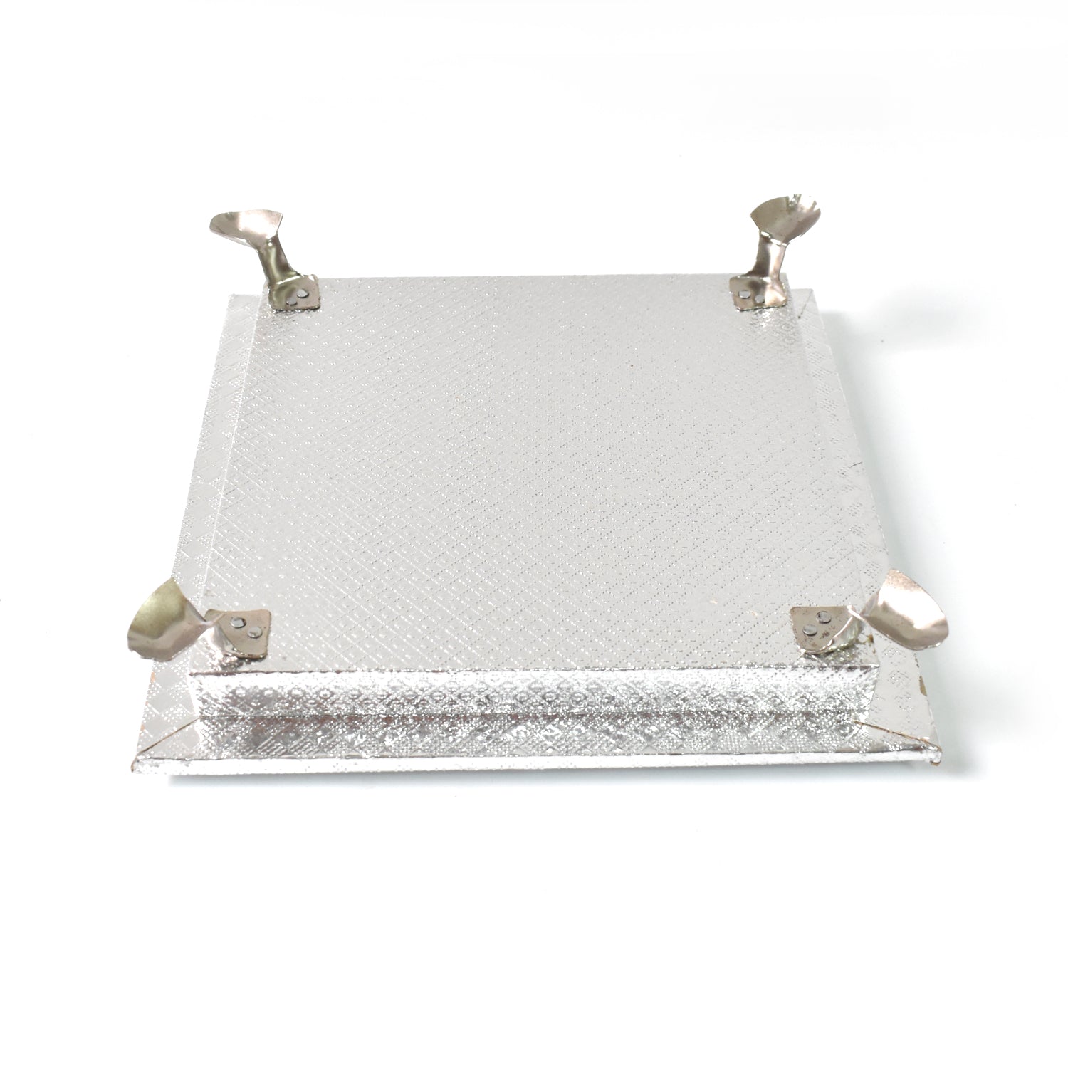 Silver pooja platform with a serene Ganesha carving, ideal for home temples and altars.