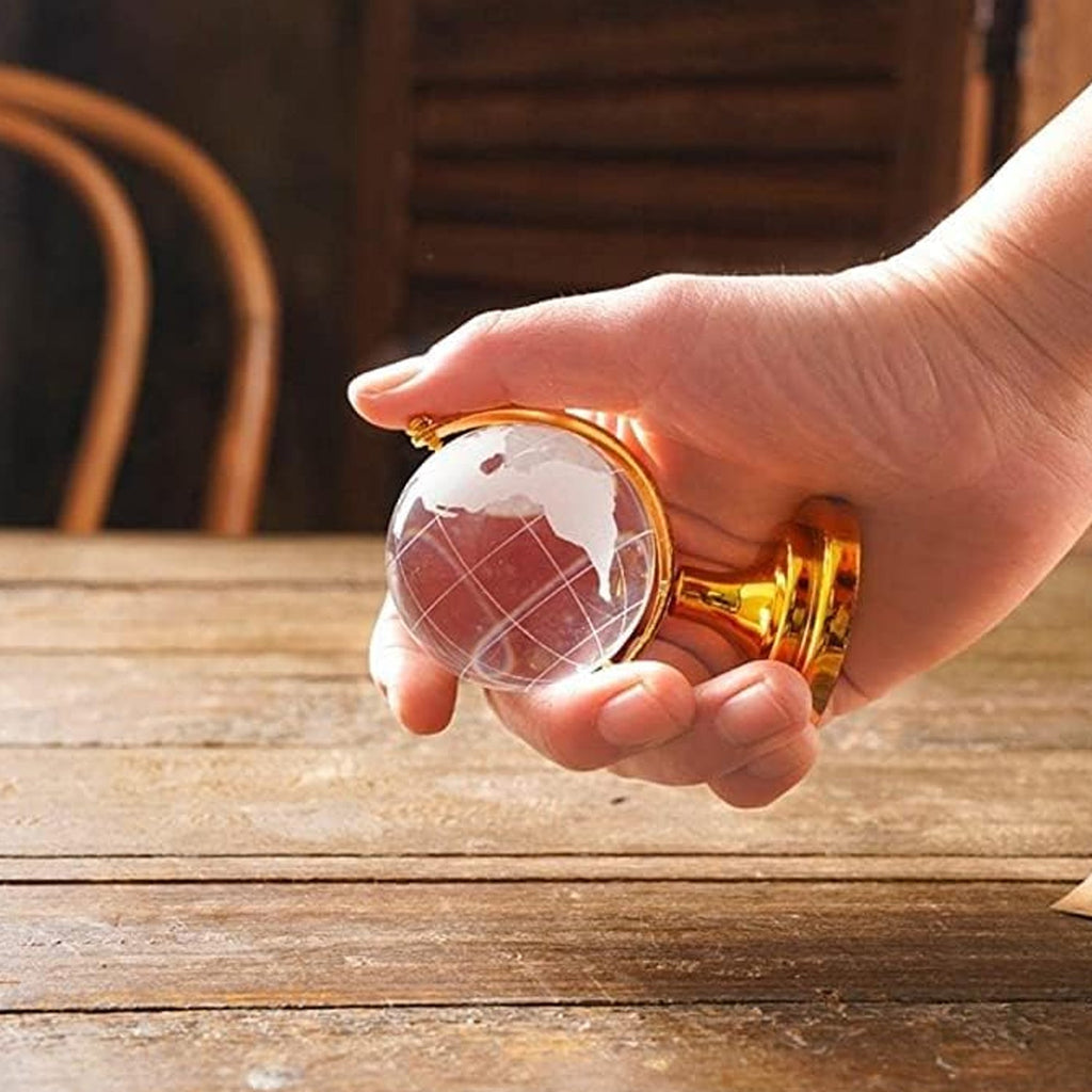 Side view of the Crystal World Globe, demonstrating its size and the intricate golden stand.