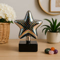 Star shaped 3D illusion LED night lamp showing multicolor light effect on a table