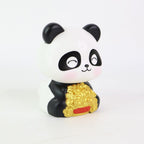 Solar panda figurine shown with its product packaging, highlighting its gift appeal.