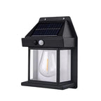 Hand holding a Solar Wall Lamp to show its compact size and design.
