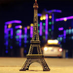 Antique finish Eiffel Tower statue on a white background.