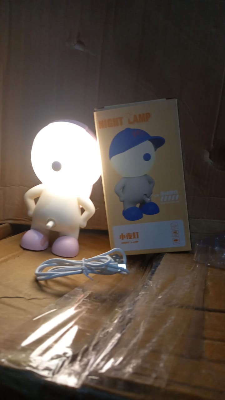 Detail of the easy-to-use button control and stable base of the cartoon LED desk lamp.