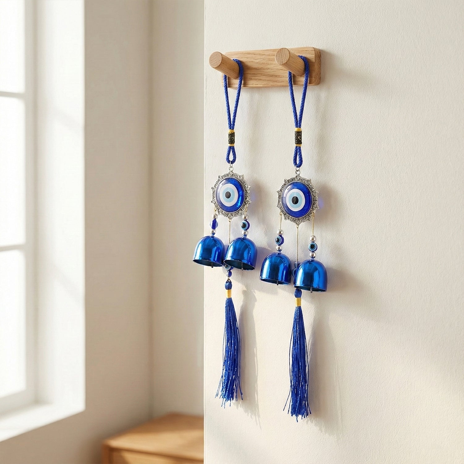 Evil eye hanging wind chime featuring traditional protective charm with bells and tassels