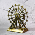 Metal desktop wheel tower ornament with intricate design on table