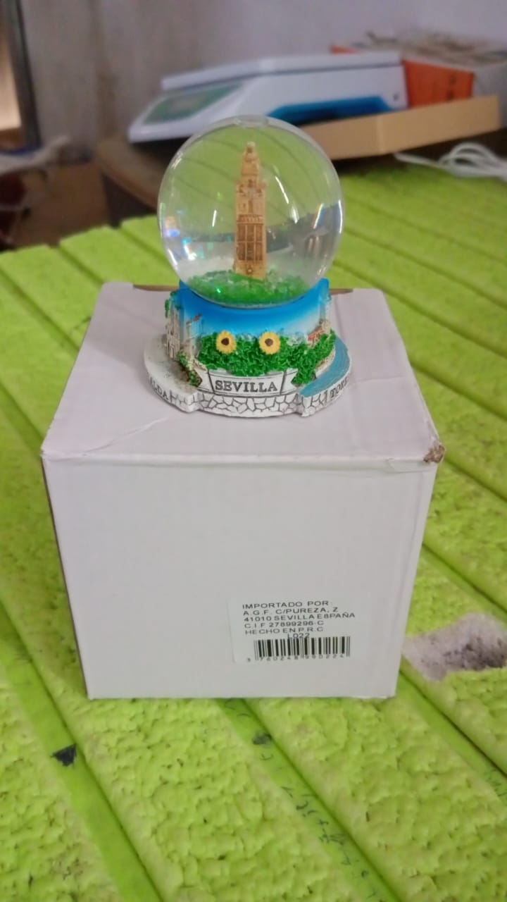Another angle of the decorative snow globe, showcasing its appeal as a unique gift item.